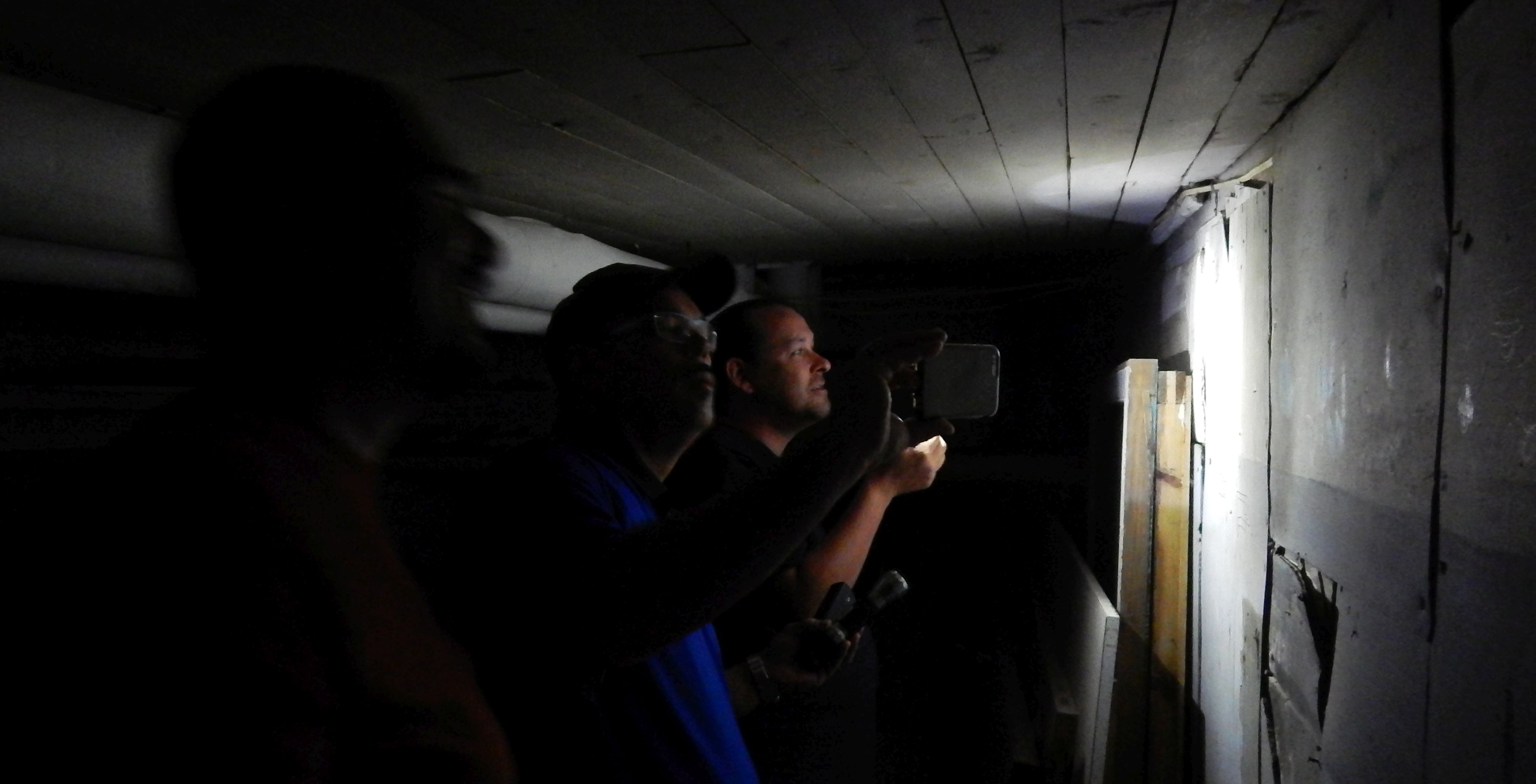 Aaron Gulyas, Greg Bishop and Tim Binnall investigating the basement of the Astor Theatre on Saturday night.
